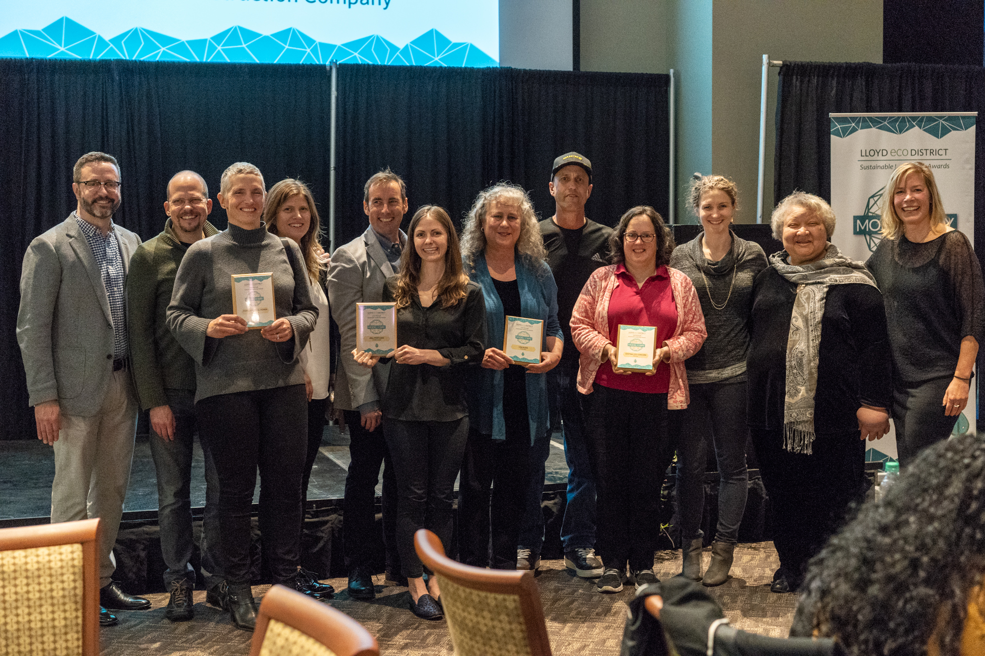 2018 Model the Way Award Winners. 10 people standing at up holding award and smiling. 