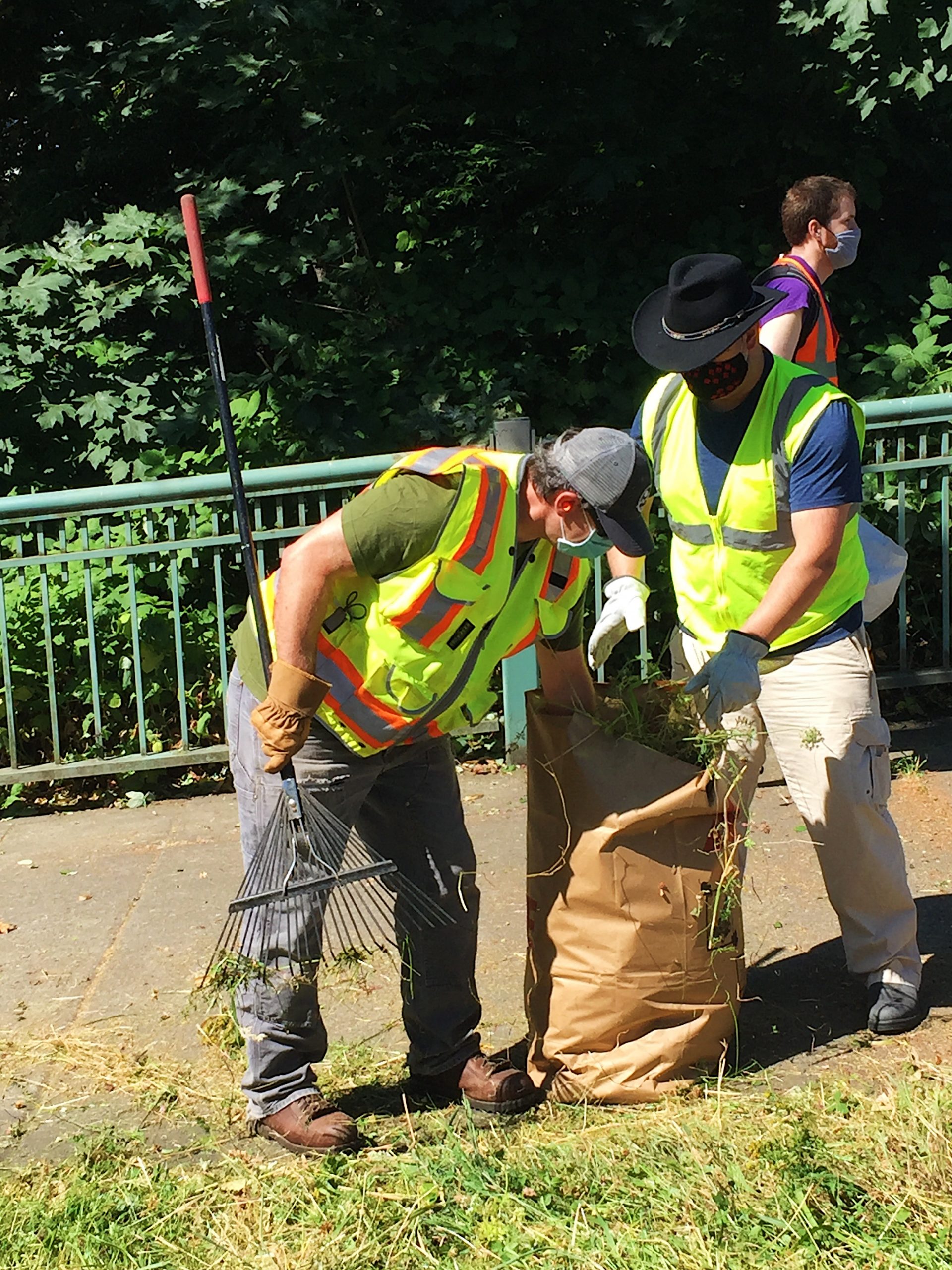 Volunteers bagging up lawn debris