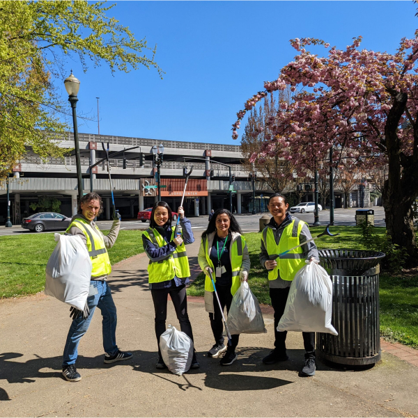 a group posing for a photo at a cleanup at Holladay Park.