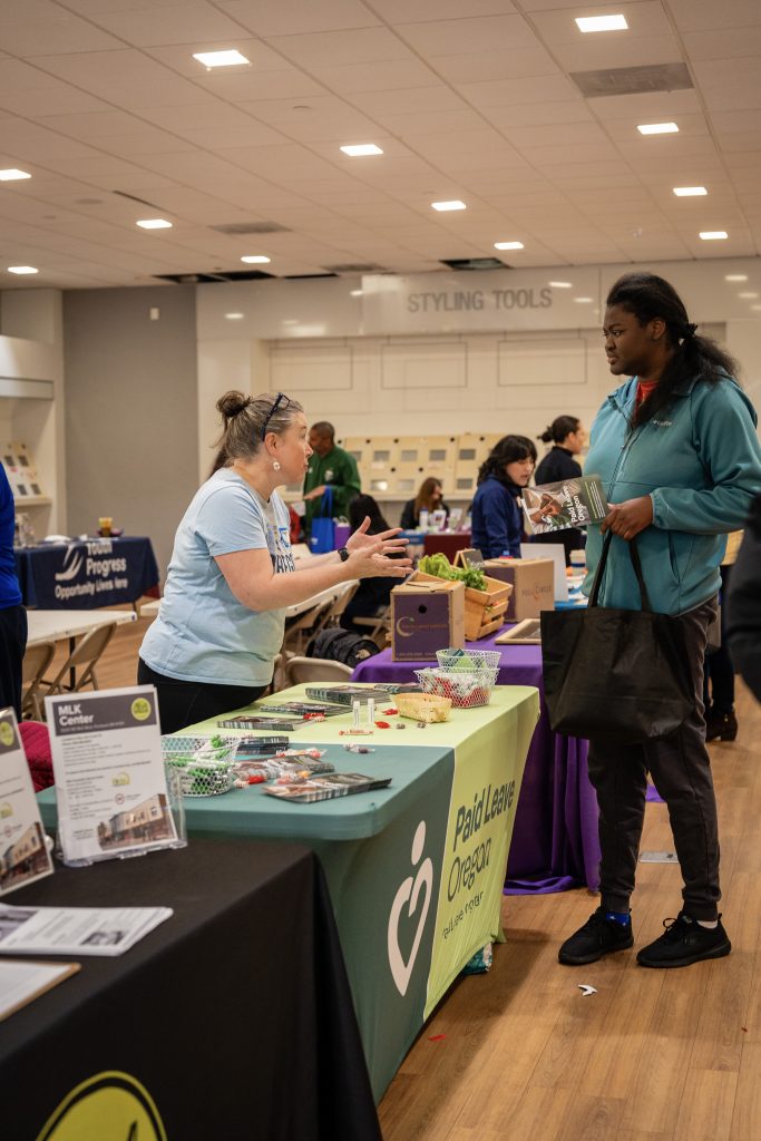 image of a community members talking with a representative of Paid Leave Oregon.
