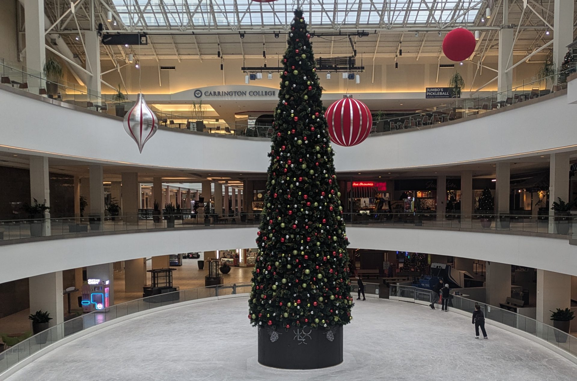 image of the Lloyd Center Ice Rink, with a christmas tree set up in the middle.