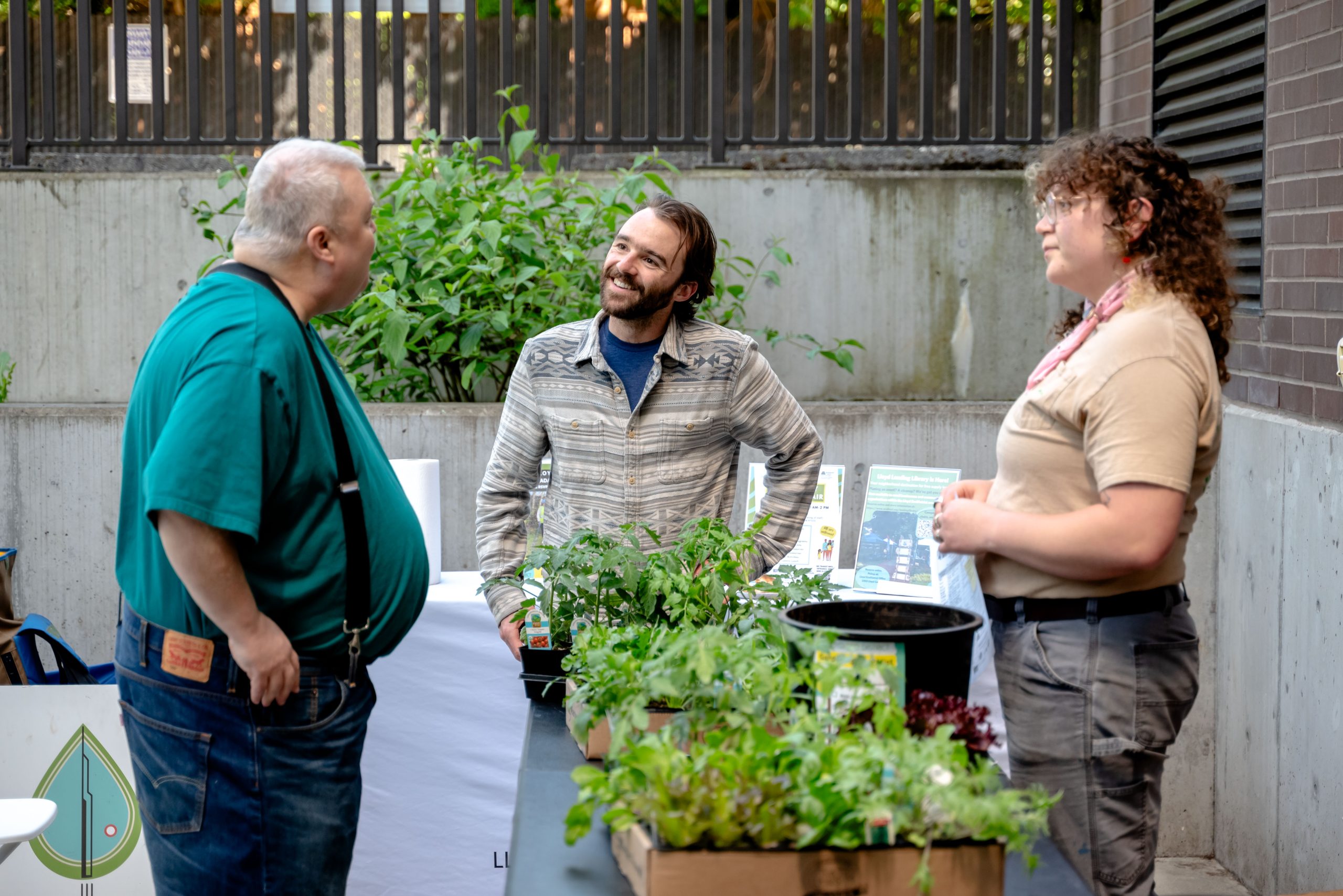 Eliot Headley chats with community members during a balcony container garden workshop.