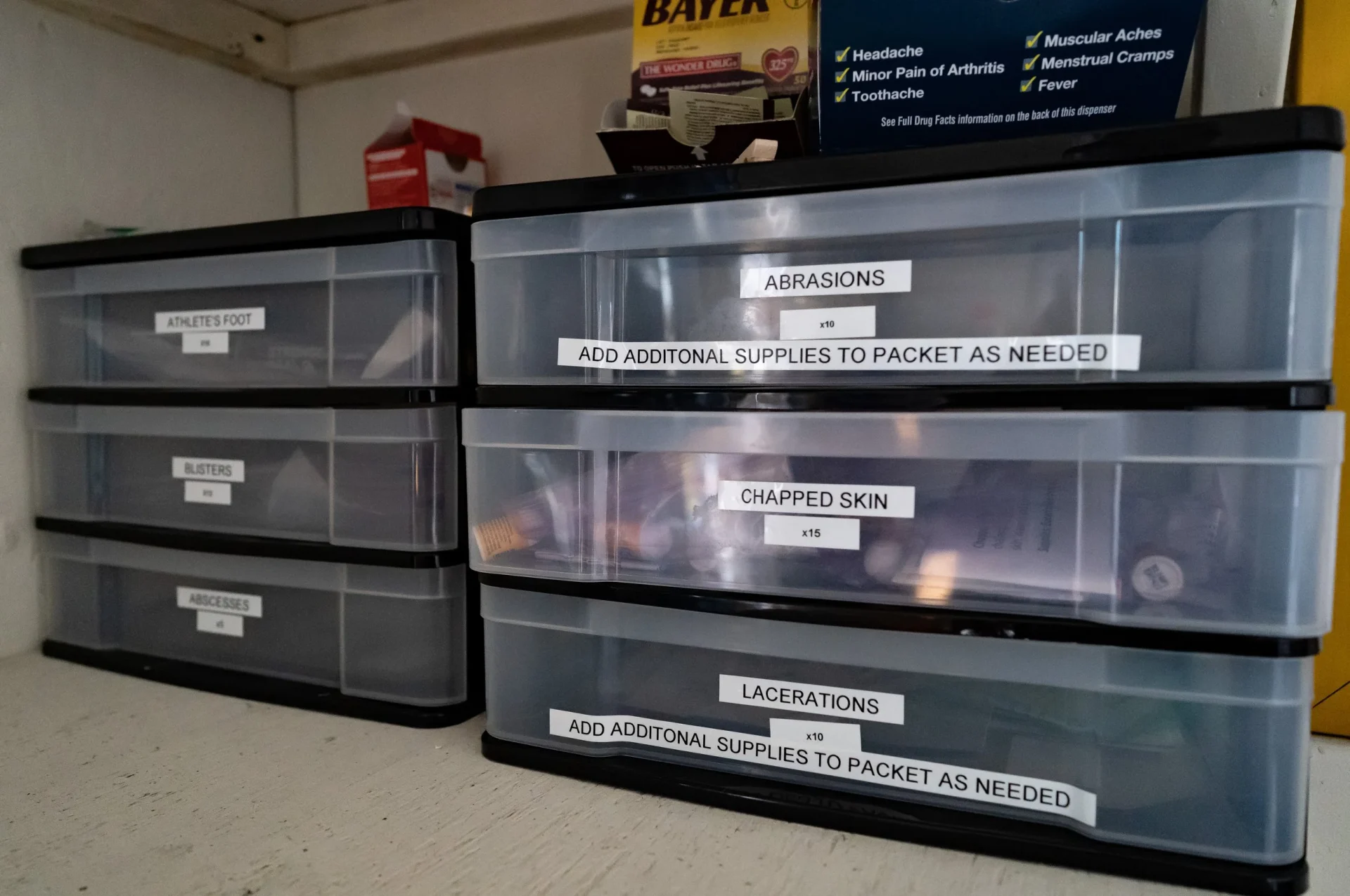 Plastic drawers labeled as containing first aid supplies