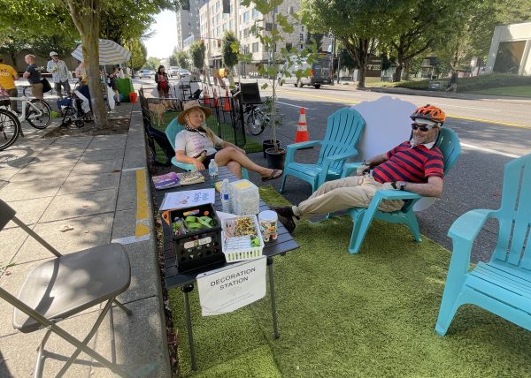 2 people sitting in lawn chairs at a "decoration station".