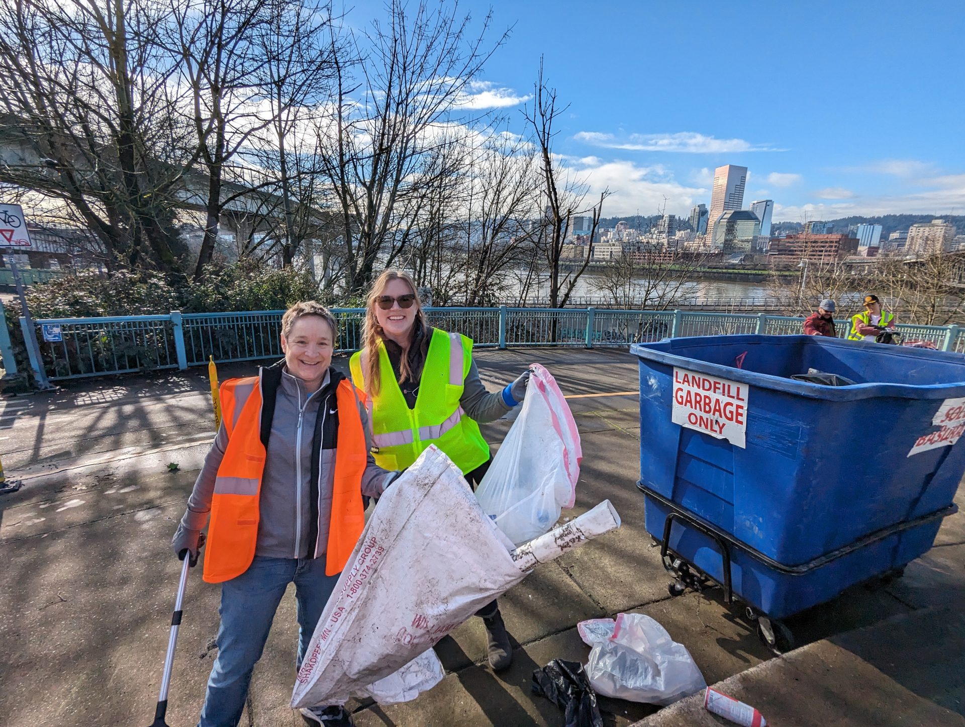 Two people posing for a photo at Peace Memorial Park, showing their cleanup progress