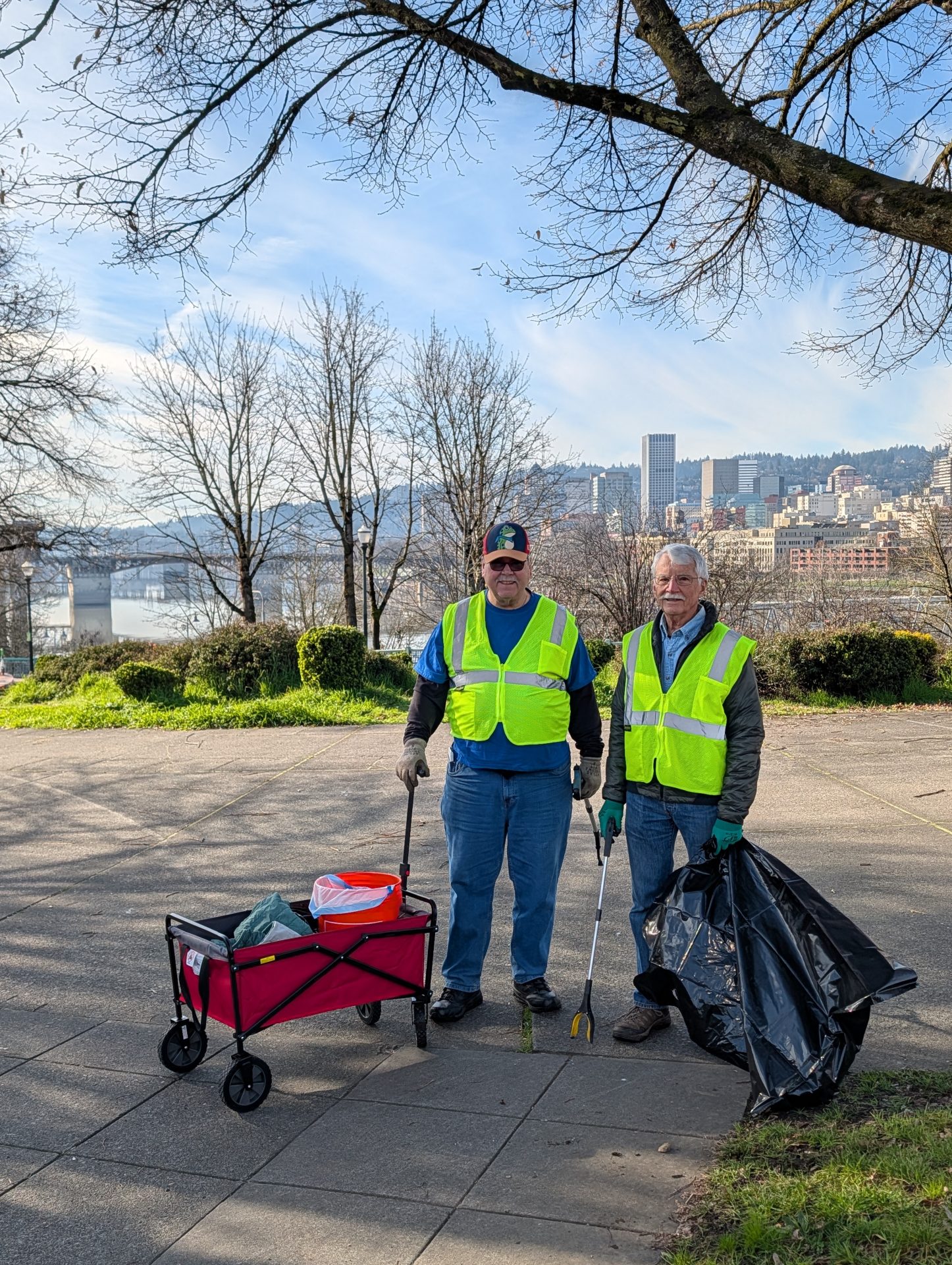 two people posing at peace memorial park, participating in the cleanup.