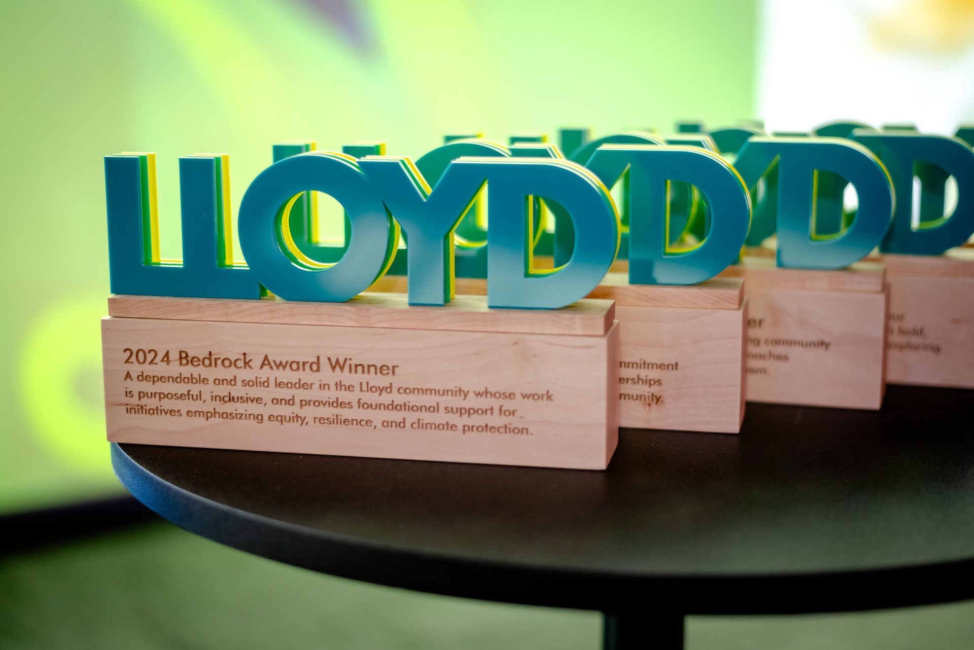 image of the Model the Way Awards on a table, with the word "Lloyd" on top of a wood block.