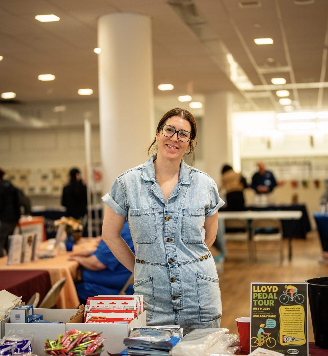 kristin stand behind the a table at an event smiling