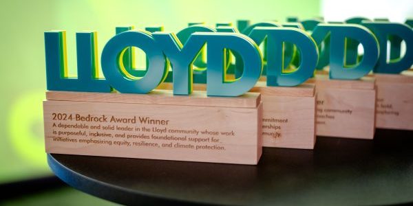 image of the Model the Way Awards on a table, with the word "Lloyd" on top of a wood block.