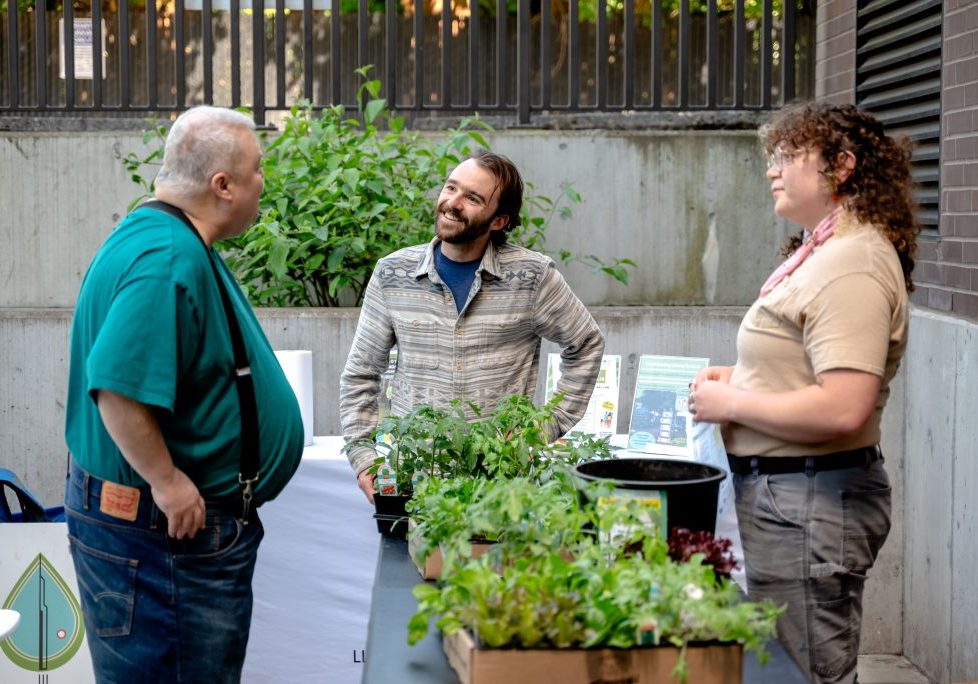 Eliot Headley chats with community members during a balcony container garden workshop.
