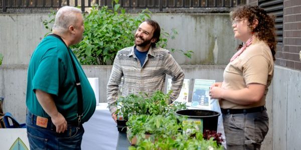 Eliot Headley chats with community members during a balcony container garden workshop.