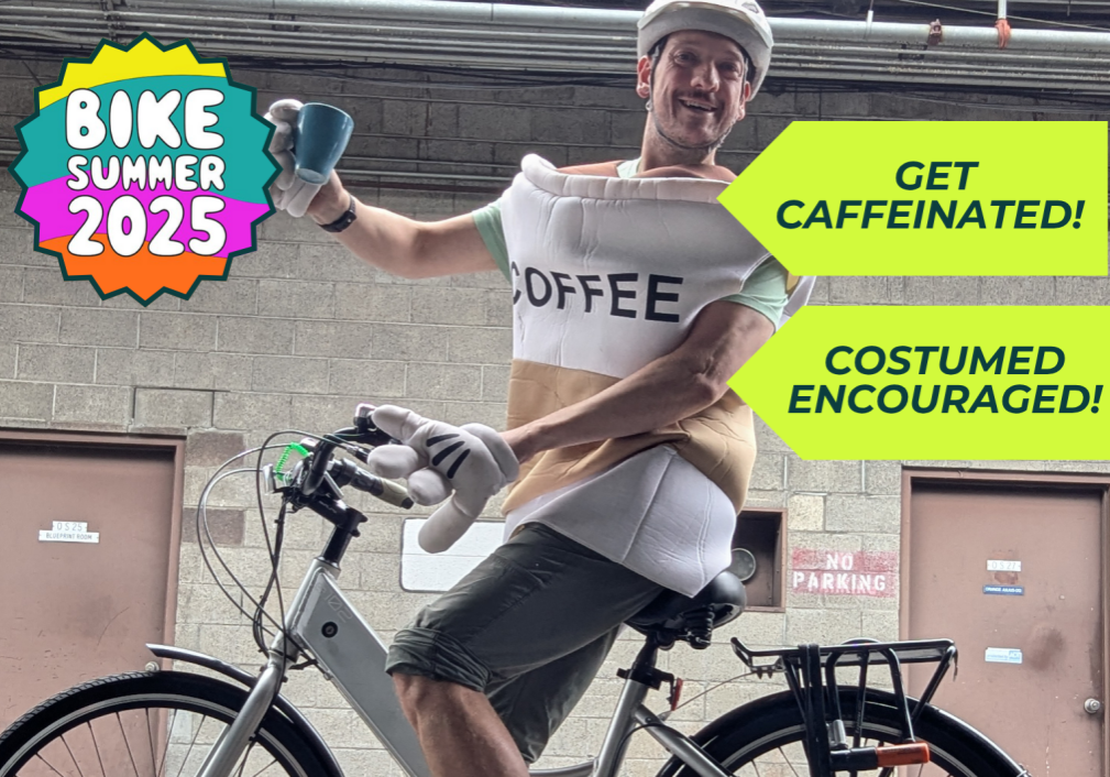 image of a person wearing a coffee cup costume riding a bike
