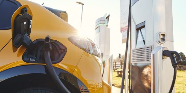 Plugged in electric car in at a EV charging station using a rapid-charger