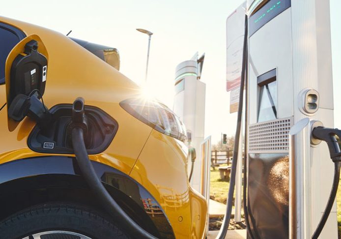 Plugged in electric car in at a EV charging station using a rapid-charger