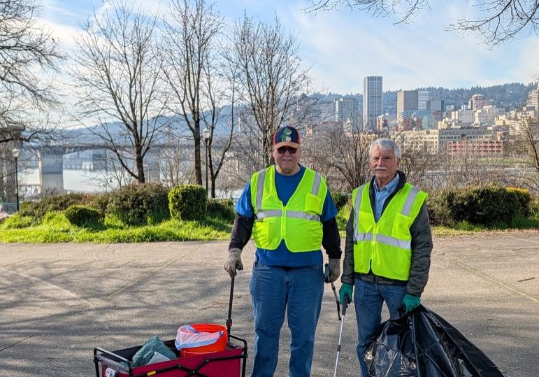 two people posing at peace memorial park, participating in the cleanup.