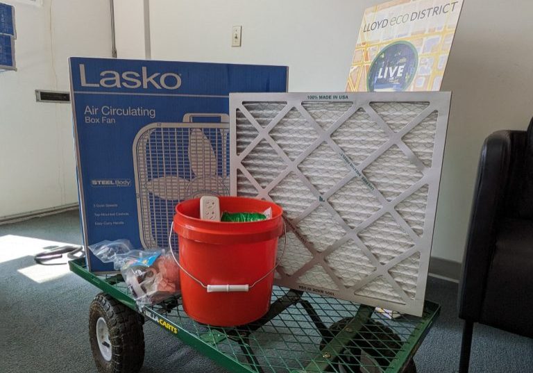 Image of a weatherization kits, including a fan, filter, and bucket of LED lights.