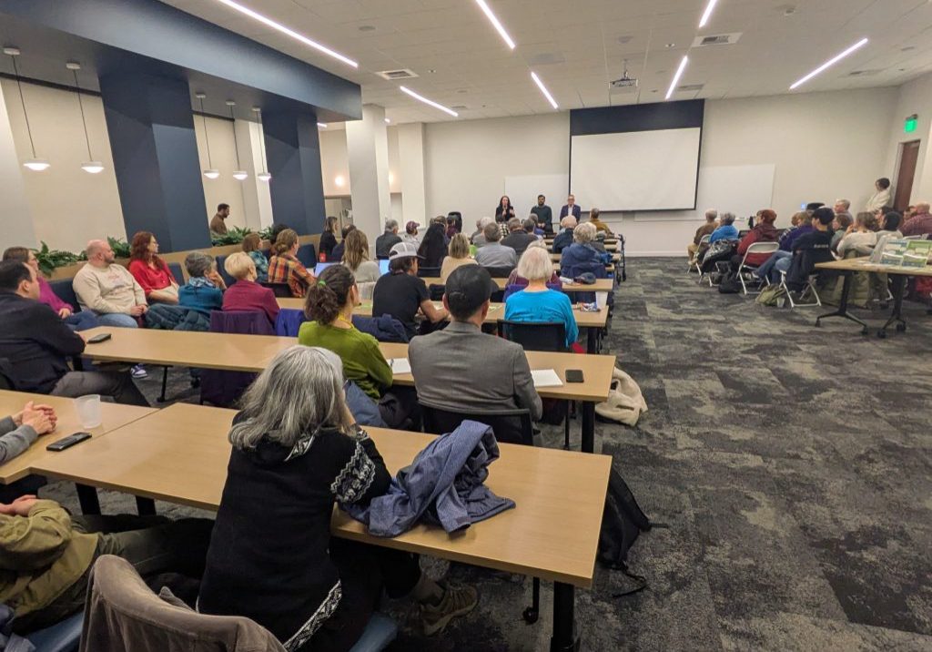 people attending a town hall conference.