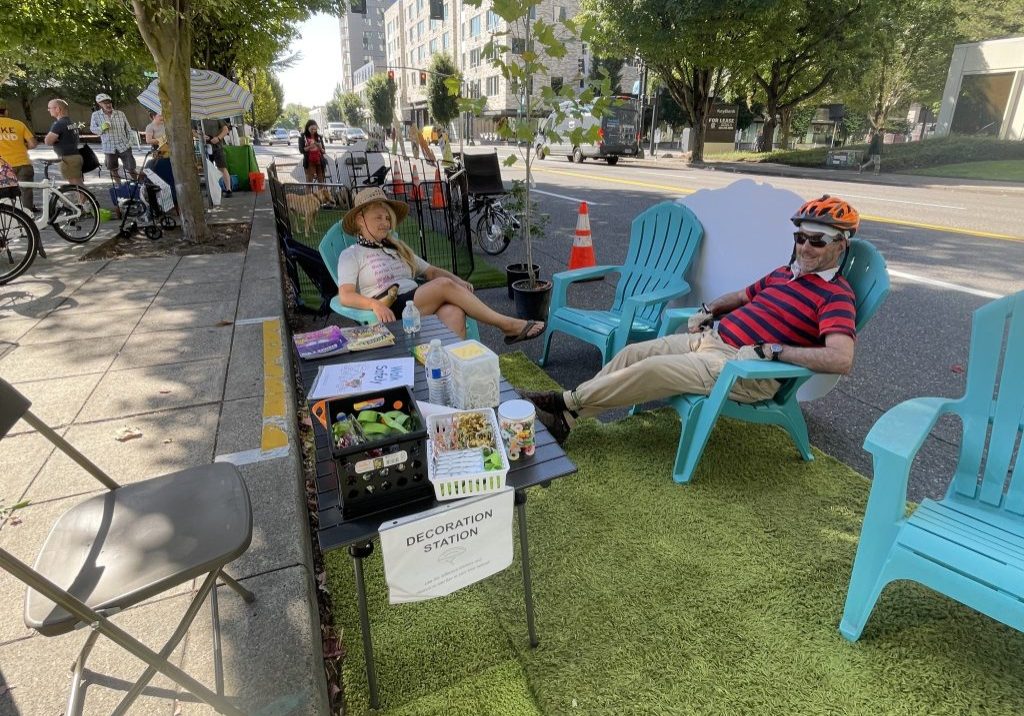 2 people sitting in lawn chairs at a "decoration station".